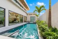 3 Bedroom House for Sale at Perla Villa, modern single-story exterior with carport, large glass doors, and flat roof.