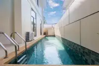 4 Bedroom House for Sale at Tadarawadi South Pattaya: Narrow private swimming pool with steps and surrounding walls.