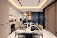 2 Bedroom Condo for Sale at Sea Sky By Sand modern dining area with marble table, built-in kitchen, and backlit wine shelves