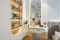 Studio Condo for Sale at Seaspire Jomtien: Elegant vanity desk with illuminated mirror and built-in shelving.