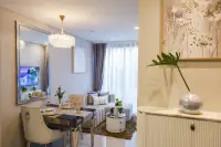 1 Bedroom Condo for Sale at Copacabana Coral Reef bright living and dining area with crystal chandelier, large wall mirror, and decorative vase