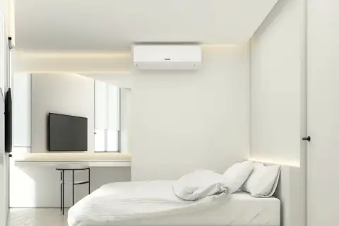 2 Bedroom Condo for Sale at Secret Garden Condominium, bedroom with bed, wall-mounted AC unit, and vanity with mirror.