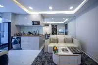 1 Bedroom Condo for Sale at Grand Solaire Noble: Modern kitchen with built-in appliances and a washing machine, next to the living area.