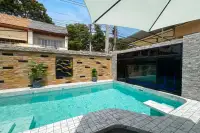 3 Bedroom House for Sale in Bang Lamung private pool with marble tile surround, stone feature wall and large glass sliding doors