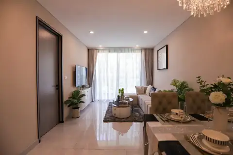 2 Bedroom Condo for Sale at Copacabana Coral Reef living room with L-shaped sofa, flat-screen TV, and floor-to-ceiling sheer curtains