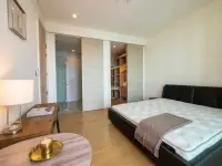 1 Bedroom Condo for Sale at Reflection Jomtien Beach bedroom with walk-in closet and ensuite bathroom