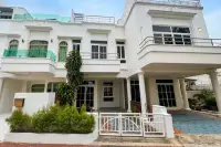 3 Bedroom House for Sale at Wongamat Exclusive Place white multi-storey exterior with balconies and gated entrance