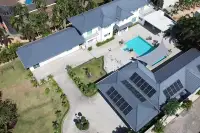 8 Bedroom House for Sale in Pong drone overview of entire estate with solar roof, pool, driveway and tropical grounds