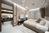 1 Bedroom Condo for Sale at Panora Estuaria: Living room with a long sofa, large TV, and floor-to-ceiling curtains.