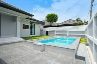 Phonthep Garden Ville 2 private outdoor swimming pool with grey tile terrace and modern single-storey house exterior