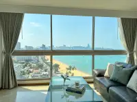 2 Bedroom Condo for Sale at Northshore Pattaya living room with leather sofa and floor-to-ceiling sea view windows