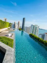2 Bedroom Condo for Sale at Baan Plai Haad rooftop infinity pool overlooking Pattaya city skyline and sea