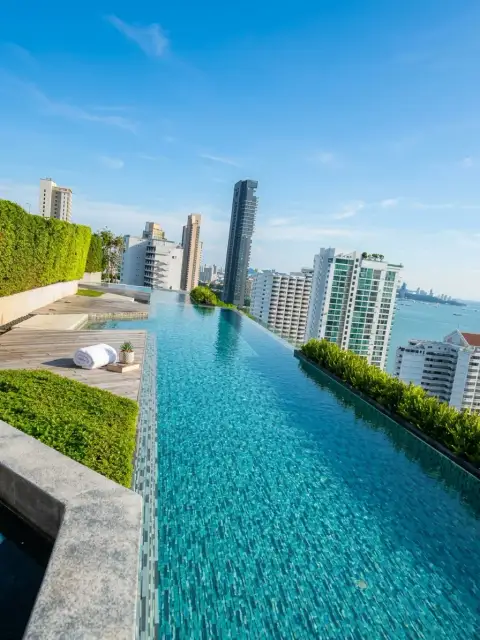 2 Bedroom Condo for Sale at Baan Plai Haad rooftop infinity pool overlooking Pattaya city skyline and sea