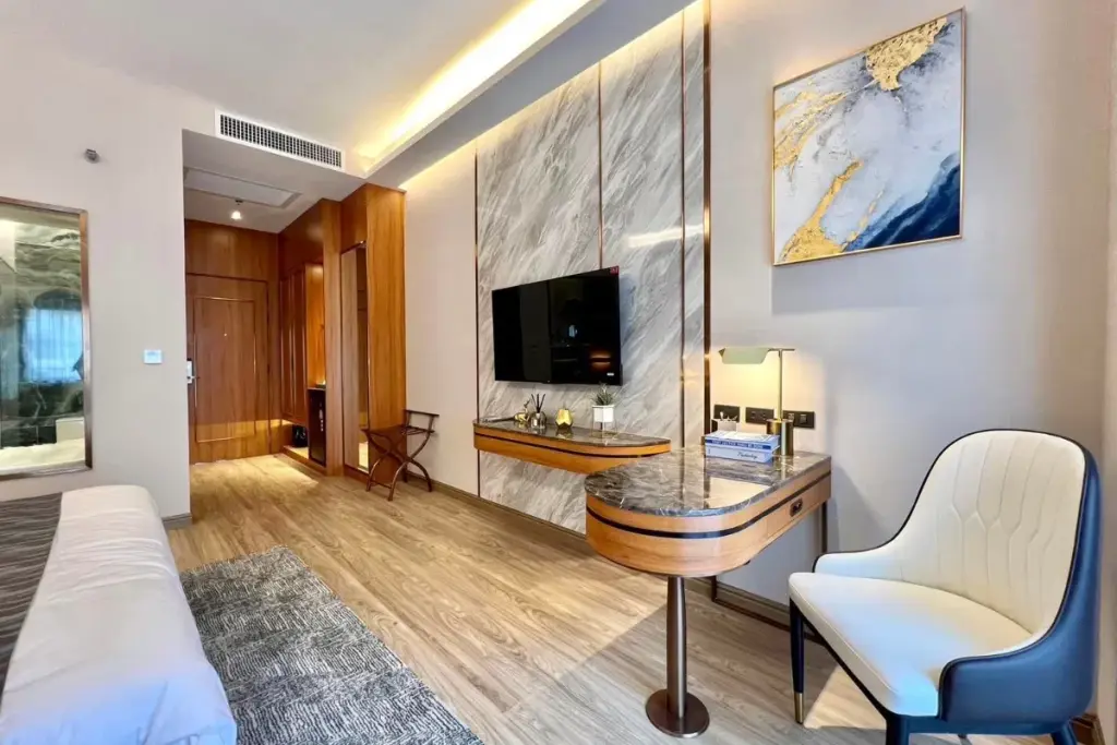 Studio Condo for Sale at Wyndham Jomtien Pattaya living area with marble wall TV unit and writing desk