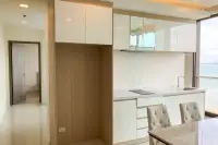 2 Bedroom Condo for Sale at Del Mare modern kitchen with white gloss cabinets, induction hob, and ocean view window