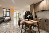 3 Bedroom House for Sale at Wongamat Exclusive Place dining area with wooden table and kitchen with wood cabinets