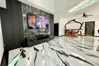 3 Bedroom House for Sale in Nong Prue living room with large TV, black and white marble floor, and unique wooden bar.