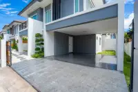 3 Bedroom House for Sale at Baan Pruksa Nara Chaiyapruek spacious covered carport with tiled driveway and landscaped entrance