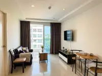 1 Bedroom Condo for Sale at Novana Residence living room with sofa, TV, dining table and balcony access