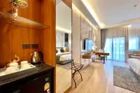 Studio Condo for Sale at Wyndham Jomtien Pattaya: cozy living area with a sofa, coffee table, and soft lighting.