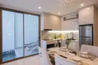 1 Bedroom Condo for Sale at Copacabana Coral Reef modern kitchen with marble backsplash, crystal chandelier, dining table and private pool view