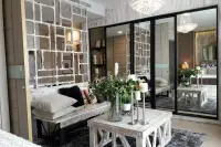 1 Bedroom Condo for Sale at Cetus Beachfront living area with whitewashed bench, mirrored wall panels and crystal chandelier