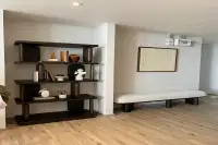 3 Bedroom Condo for Sale at Arom Wongamat hallway with dark wood display shelf and cushioned bench seating