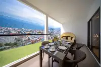 2 Bedroom Condo for Sale at Grand Solaire Noble spacious balcony with rattan dining set and sweeping Pattaya bay and city view
