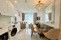 1 Bedroom Condo for Rent at Copacabana Beach Jomtien bright open-plan interior with sea view balcony, dining table, and kitchen