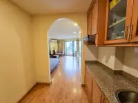 1 Bedroom Condo for Sale at View Talay 2 hallway with granite kitchen counter and arched entrance to living area