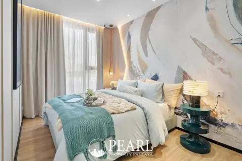 2 Bedroom Condo for Sale at Aquarous Jomtien Pattaya bedroom with abstract mural accent wall and city view window