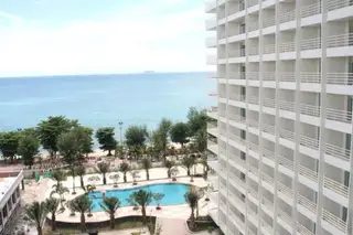 View Talay 7 aerial view of the condo complex, large pool, and beach with ocean beyond.