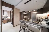 1 Bedroom Condo for Sale at Panora Estuaria: Living room with a long sofa, large TV, and floor-to-ceiling curtains.