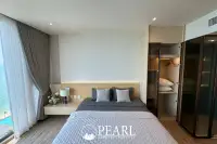 1 Bedroom Condo for Rent in Arom Wongamat bedroom with king-size bed and city view