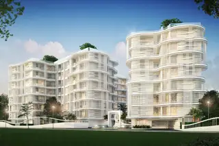 The Coral Pattaya, two modern white condo buildings with curved balconies and green landscaping.