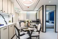 2 Bedroom Condo for Sale at Embassy Life, dining table set for four, kitchen, and living area with bedroom entry.
