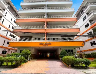 New Nordic Trend 2 building entrance with orange facade and covered driveway
