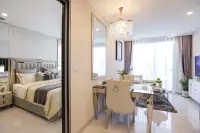 1 Bedroom Condo for Sale at Copacabana Coral Reef interior view showing bedroom reflection in mirrored wardrobe and dining area