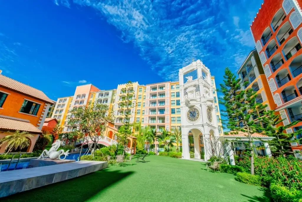 Venetian Signature Condo Resort Pattaya clock tower with pool statue and colorful Venetian-style buildings