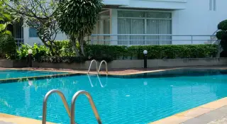 Rama Harbour View outdoor swimming pool with ladder and lush landscaped garden