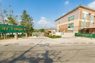 SP Village 3 Pattaya gated community entrance with green signage and multi-storey townhouses