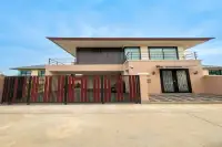 3 Bedroom House for Sale at Villa Asiatic modern two-storey exterior with red sliding gate and ornate front door