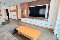 3 Bedroom House for Sale at Royal Prestige modern living room with large wall-mounted TV, wood accent cabinetry and coffee table