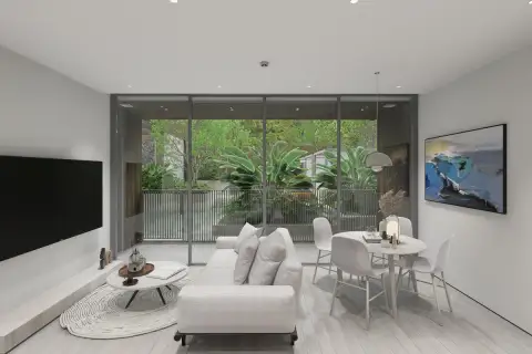1 Bedroom Condo for Sale at Celine Wongamat bright living room with floor-to-ceiling glass doors opening to lush tropical garden