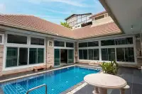 4 Bedroom House for Sale & Rent in Bang Lamung private outdoor swimming pool with tiled deck and large glass sliding doors
