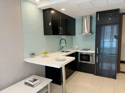 1 Bedroom Condo for Sale at Grand Avenue Residence compact kitchen with mint tile backsplash and black cabinets