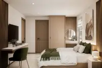 2 Bedroom Condo for Sale at Siam Oriental Beach: cozy bedroom with a large bed, wooden paneling, TV, and a vanity area with a round mirror.