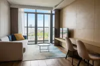 1 Bedroom Condo for Rent at Beverly Mountain Bay Pattaya lounge with sofa, TV console, and panoramic city skyline view
