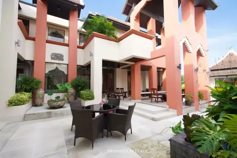 Phutara outdoor patio with a dining table and chairs, surrounded by the house's modern Thai-style architecture.