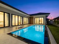 3 Bedroom House for Rent at Garden Ville 9 private pool and patio illuminated at twilight